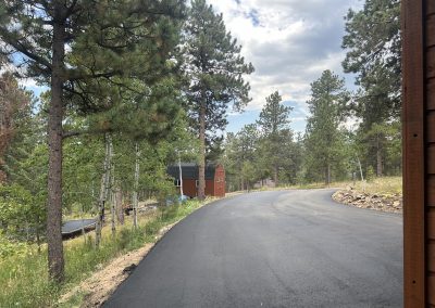 Freshly paved asphalt driveway at a country residence